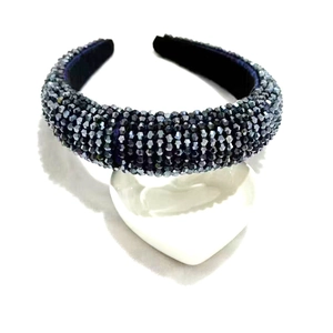 Detail of dark crystal beaded wide headband with faceted grey stones on a white tray
