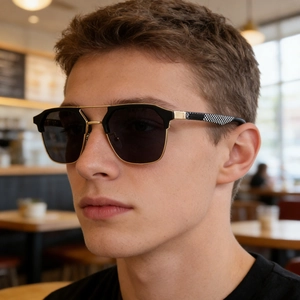 Close-up of men's cat-eye sunglasses featuring gold double bridge and checkered temples