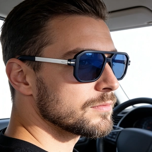 Detail of square polarized blue lens sunglasses with silver temple accents in car
