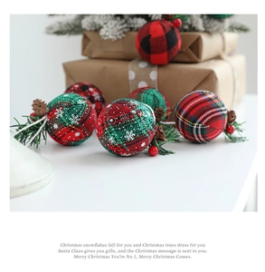 Detail of fabric Christmas balls with pine cones, red berries and plaid patterns
