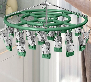 Detailed view of a green multi-clip laundry drying rack with durable stainless steel pegs