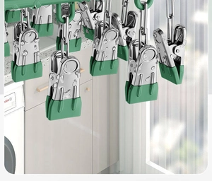 Macro view of durable stainless steel clothes clips featuring green non-slip silicone tips