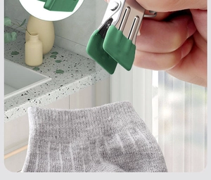 Close-up of durable stainless steel clothes peg with green silicone tips for drying socks