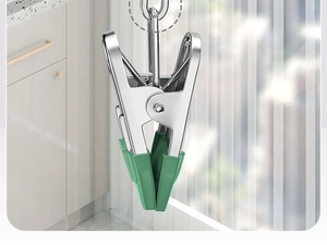 Detailed view of heavy-duty stainless steel laundry clip with green non-slip silicone pads