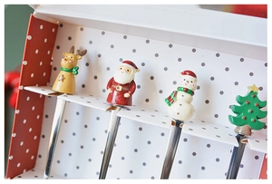 Detailed view of 304 stainless steel dessert spoons with 3D resin Christmas figures