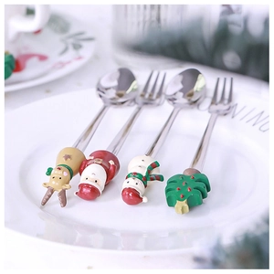 Detail of Christmas cutlery set with resin Santa, deer, and tree charms on steel spoons