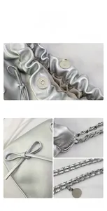 Dettaglio della borsa a secchiello argento con chiusura magnetica e fiocco in pelle
