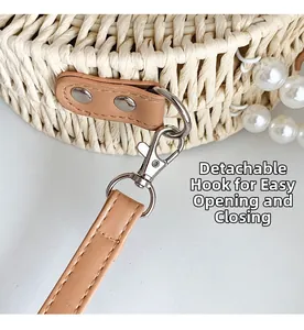 Detail of hand-woven bag with silver metal swivel hook and pearl chain decoration