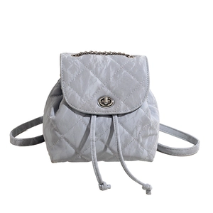 Light gray quilted backpack with diamond stitching and silver twist lock in casual style