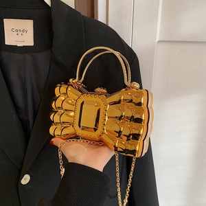 Golden bow-shaped acrylic evening bag with ripple texture and metal chain handle
