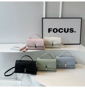 Detail of five woven leather crossbody bags in pastel colors with metal locks