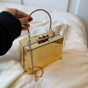 Polished gold metal box clutch with snake-bone handle and removable chain strap