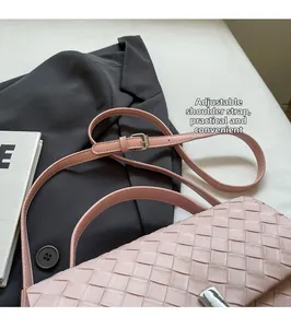 Detail of light pink woven crossbody bag with adjustable strap and textured surface