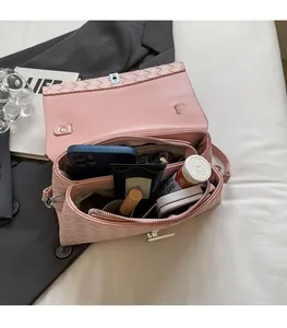 Detailed interior of pink woven crossbody bag showing spacious dual compartments