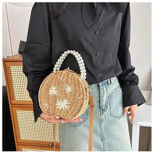 Handwoven straw round bag with daisy flower accents and elegant pearl bead handle
