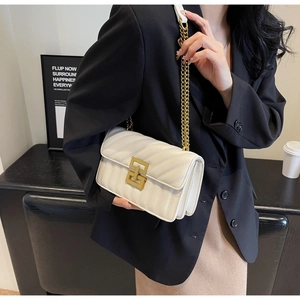 Detail of creamy white quilted leather bag with elegant matte gold geometric square clasp