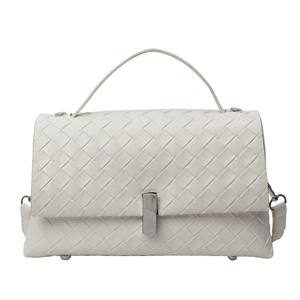 White woven leather crossbody bag with silver clasp and top handle on white background