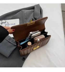 Detailed interior of brown quilted crossbody bag showing multiple storage compartments