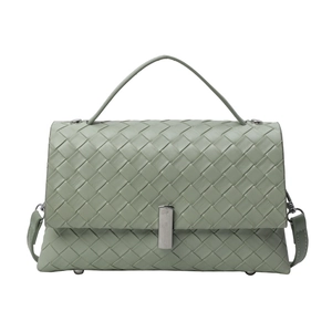 Light green woven leather shoulder bag with top handle and crossbody strap in a boxy shape