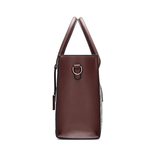 Close-up of wine red crossbody bag showing crocodile pattern texture and side metal buckle