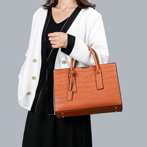 Crocodile embossed caramel leather tote bag with metallic bar and matching pendant charm