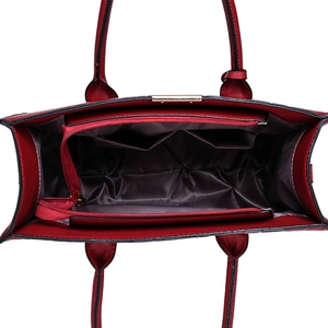 Interior view of red quilted handbag with multi-compartments and gold zipper hardware