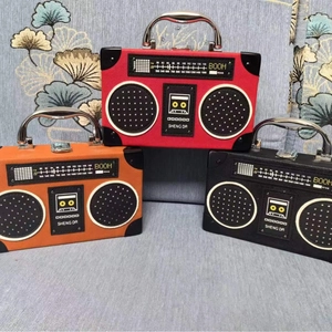 Detailed close-up of retro radio style handbags in red, black, and brown faux leather