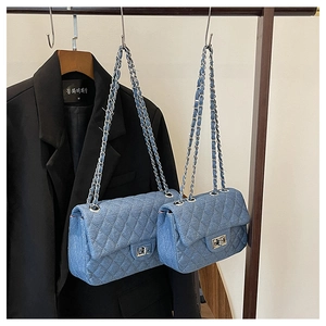 Detail of denim quilted chain bags in small and large sizes with silver twist locks