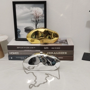 Modern metallic wave evening bag in gold and silver mirror finish with chain strap
