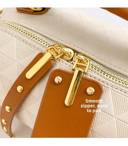 Macro detail of high-gloss gold smooth zipper and embossed triangle texture on cream bag