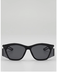 Close-up of black sports sunglasses with side shields and glossy finish for cycling