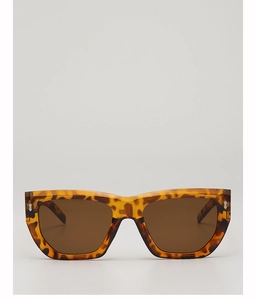Detail of tortoise shell sunglasses with brown lenses and metal dot accents