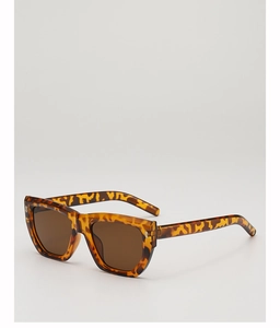 Detailed 45-degree angle of tortoiseshell sunglasses showing hinge and metal accents