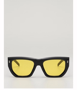 Detail of silver cross metal hinge on black polygon sunglasses with yellow lenses