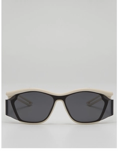 Close-up of cream sports sunglasses featuring wide frames and dark grey protective lenses