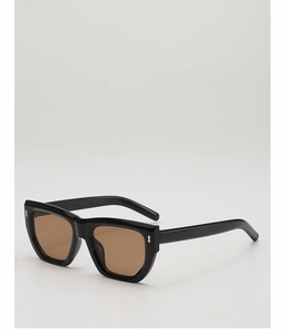 Close-up of stylish polygon sunglasses featuring thick black frames and silver metal accents