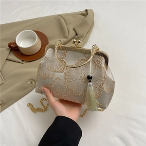 Elegant champagne satin evening bag with gold flower embroidery and tassel detail