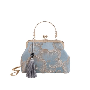 Light blue evening bag with gold flower embroidery, metal handle and tassel fringe