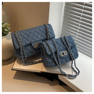 Quilted denim chain bag in navy blue with silver clasp shown in two versatile sizes
