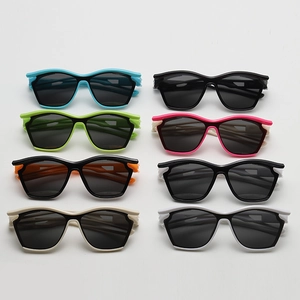 Flat lay of eight colorful kids sports sunglasses with wavy frames and UV protection