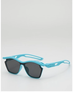 Detail of bright blue kids sports sunglasses with grey lenses and hollowed-out temples