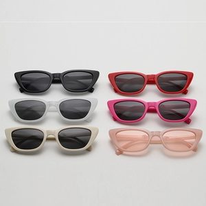 Flat lay of retro cat eye children's sunglasses in six colors on minimalist background
