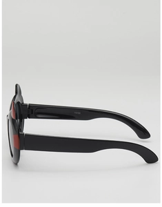 Detail view of cartoon little devil sunglasses with cat ears and red horn accents