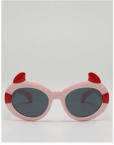 Detail of pink cartoon devil sunglasses with red horns and dark gray lenses for kids