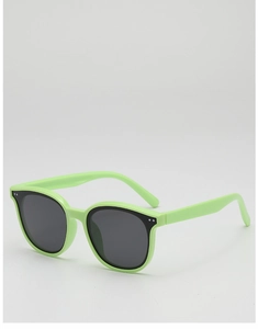Détail de lunettes de soleil enfant vert néon avec verres ronds gris et points en métal