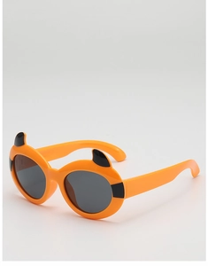 Close-up of kids' cartoon devil sunglasses with orange frames and black horns