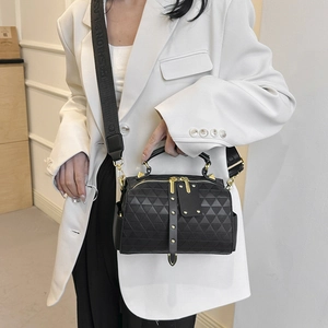 Black quilted crossbody handbag with gold rivets and wide letter print shoulder strap