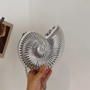 Silver nautilus shell clutch bag with metallic texture and delicate chain strap
