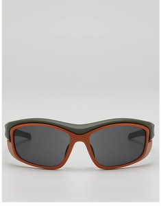 Close-up of olive green and orange sport sunglasses with wrap-around frame design
