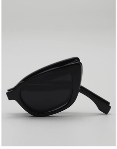 Close-up of foldable black cat-eye sunglasses with glossy frames and dark lenses